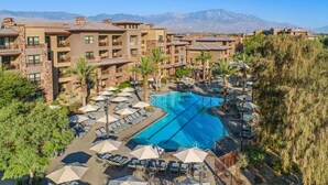 A resort with a central swimming pool, multiple balconies, and a mountainous backdrop. - Discover Family Fun and Luxury at The Westin Desert Willow Villas – 1 Bd Premium (Palm Desert)