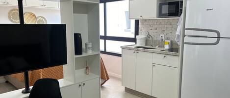 Fridge, microwave, coffee/tea maker, cookware/dishes/utensils