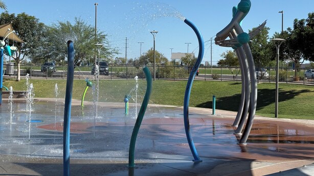 A water feature with multiple fountains and a sculpture in a public park. - Relax in the Gilbert Getaway (Gilbert)