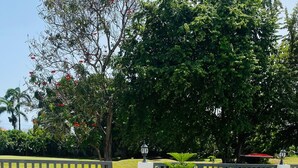 A gated entrance with a pathway leading to a grassy area. - Small apartment-style villa near the beach (Puerto Plata)