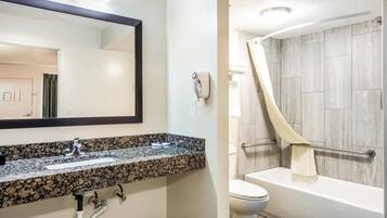 Basic Room, 1 King Bed, Accessible Bathtub, Non Smoking | Bathroom | Bathtub, hair dryer, towels, soap