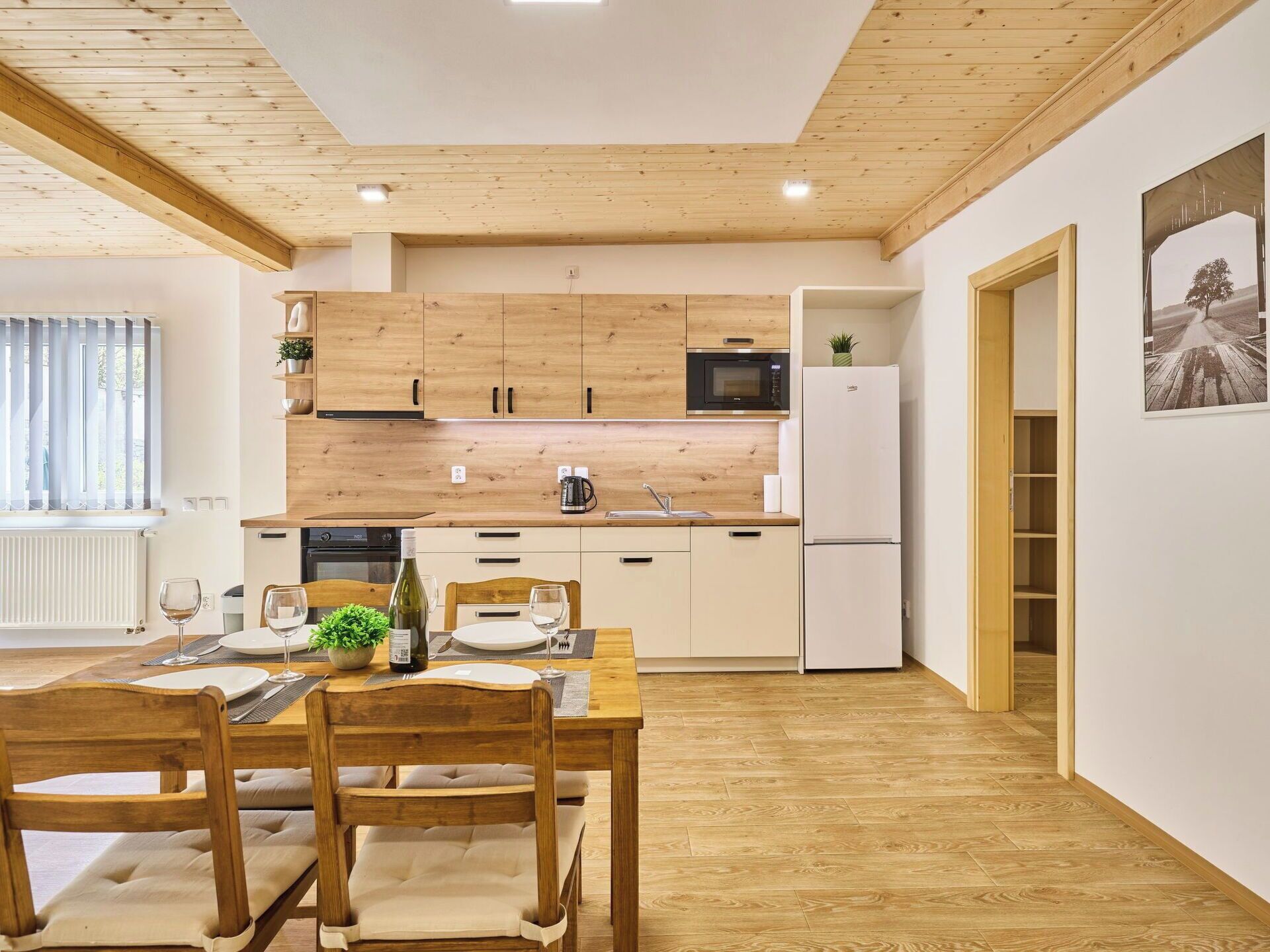 A modern kitchen with wooden cabinets, a microwave, and a refrigerator.
