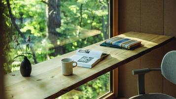 A wooden desk with a vase, a mug, and a book.