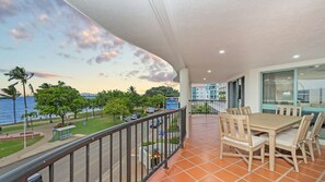 A balcony with a view of the sea and a sign for 'Aquarius Stay'.