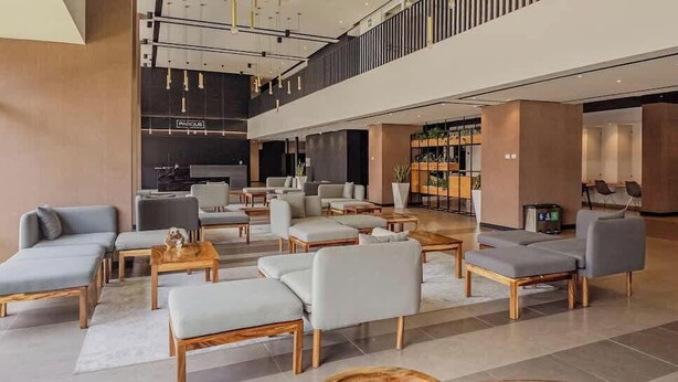 A spacious lobby with modern seating, a reception desk, and a plant display. - Volcano Views Luxury w/ KING Bed & Free Facilities (Guate)