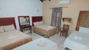 A hotel room with two single beds, a small desk, a chair, and a window with curtains. - Ecoturismo Monte Horeb (Gracias)