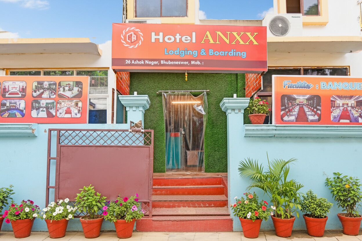 A hotel entrance with a sign reading "Hotel ANXX Lodging & Boarding" and a banner advertising a banquet facility.