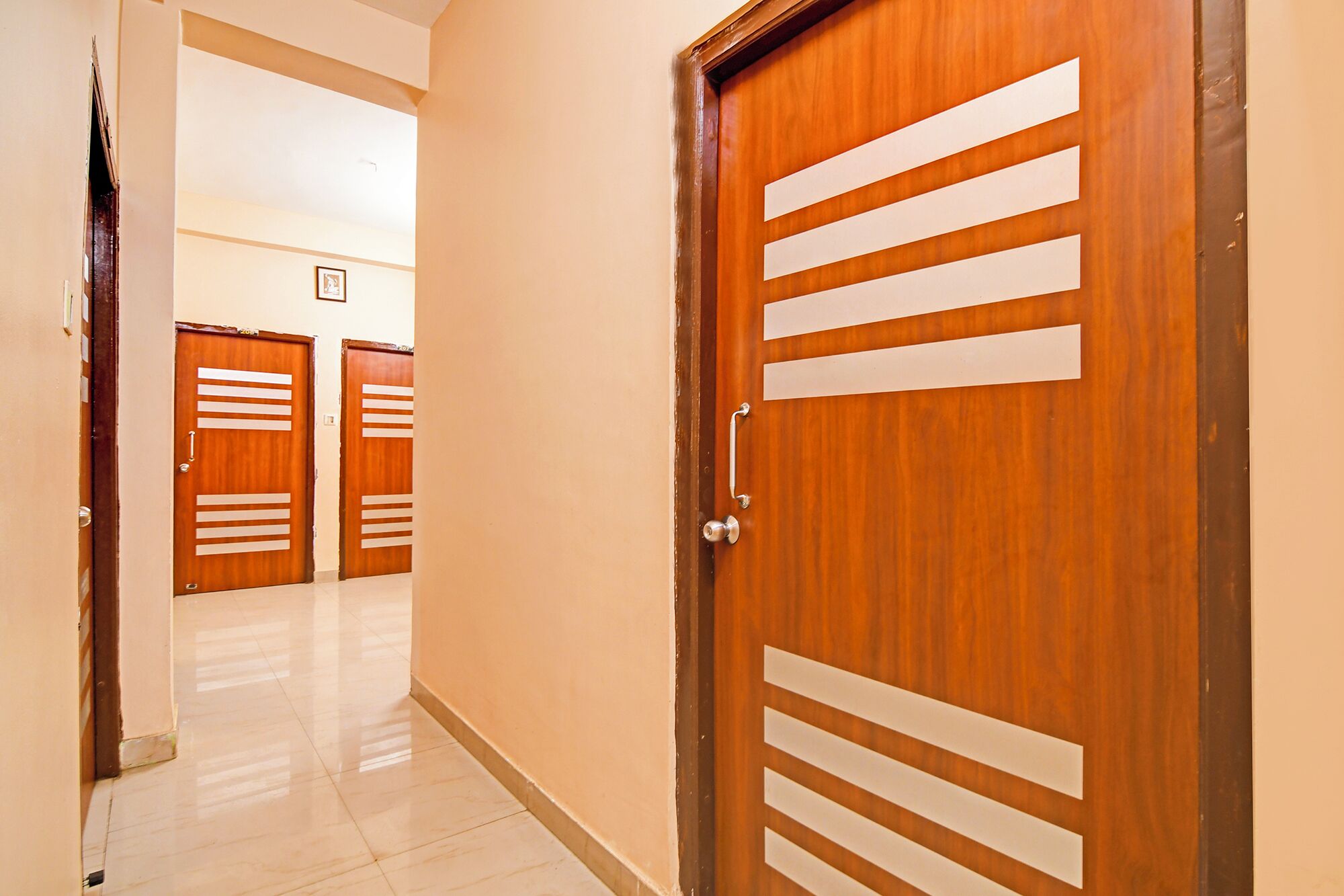 A hallway with wooden doors, each featuring horizontal slats.