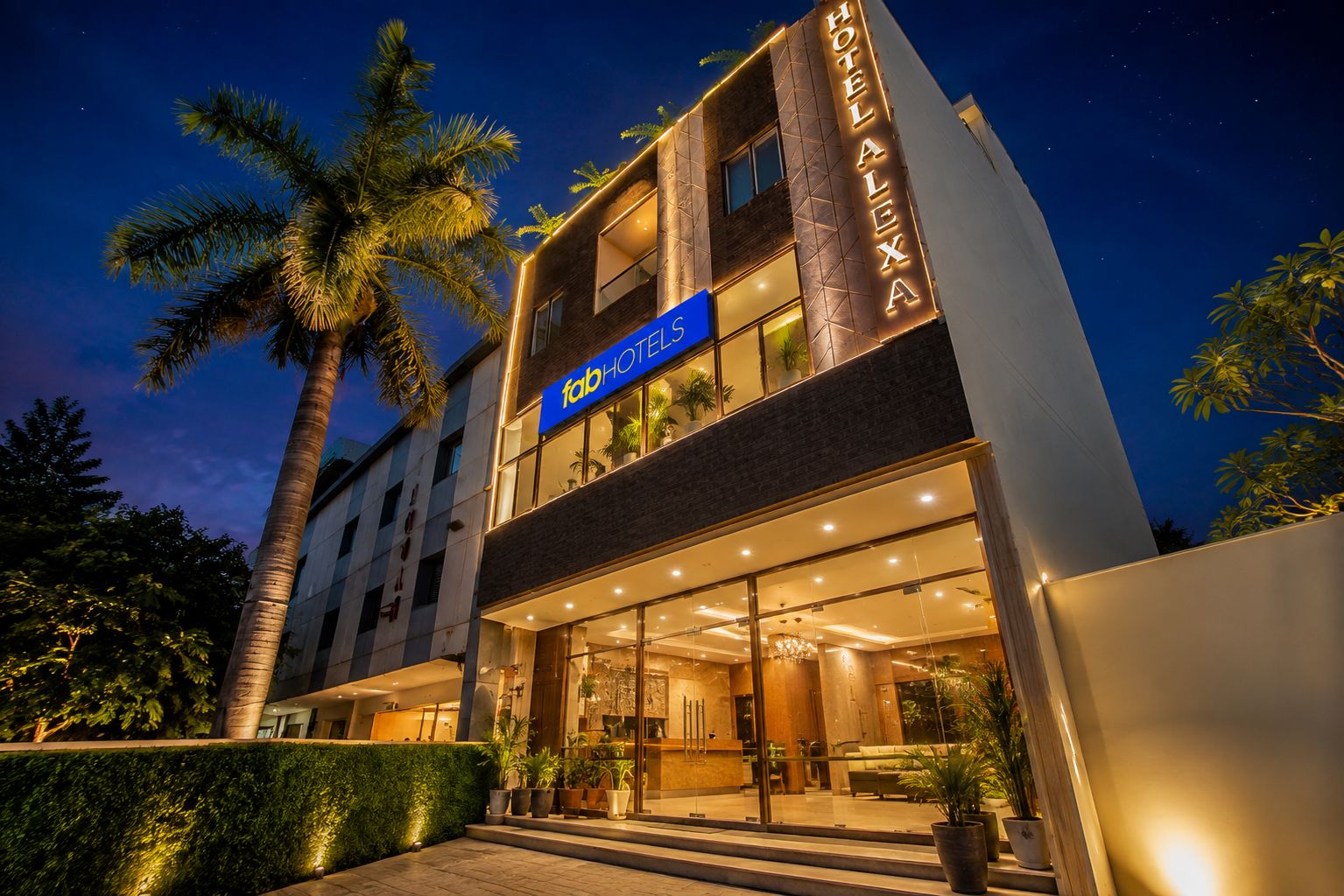 A multi-story hotel with a prominent sign reading 'fab HOTEL ALEXA.'