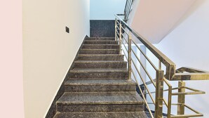 A staircase with marble steps and a metal handrail. - Fabhotel Pink Palace Raja Park (Jaipur)