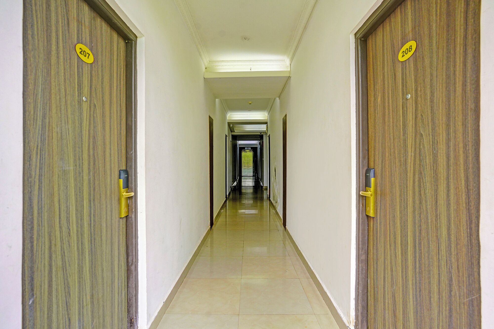 A hallway with two wooden doors, each marked with a number.