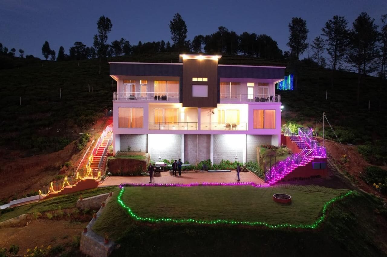 A modern two-story building with a central courtyard, a staircase, and a well-lit exterior.