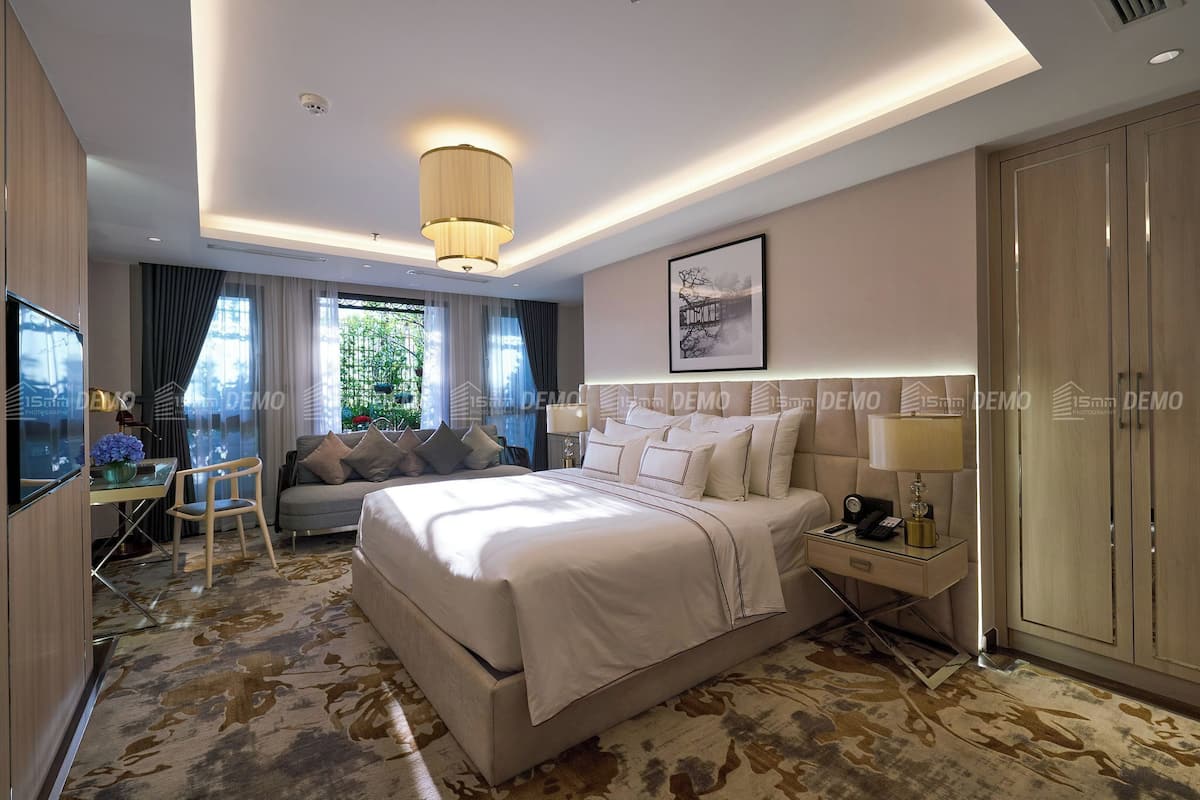 A modern hotel room with a large bed, a desk, and a wardrobe.