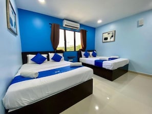 A hotel room with two beds, blue walls, and an air conditioning unit. - Royals Star Hotel (Seremban)