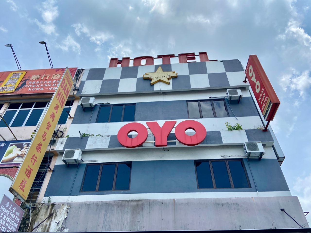 A hotel with a checkered facade and the name "OYO" prominently displayed.