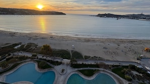 A resort with a large pool area, a beach, and a sunset view. - Costa Herradura (Coquimbo)