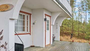 A building with a white exterior, a wooden deck, and a sign that reads 'TukaLilla'.