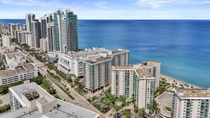 A coastal cityscape with high-rise buildings, a beach, and a clear sky. - Beachfront Getaway | Direct Ocean Views + Balcony (Hollywood)
