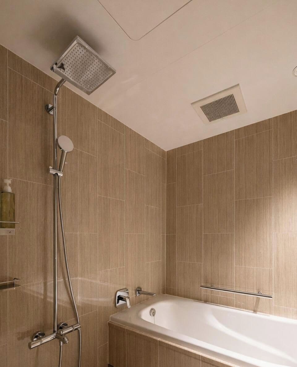 A modern bathroom with a shower, a bathtub, and a toilet.