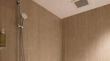 A modern bathroom with a shower, a bathtub, and a toilet.