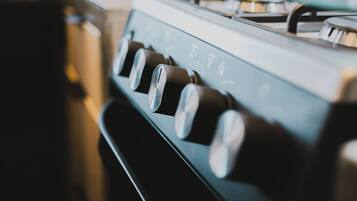 A close-up of a stove's control knobs.