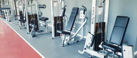 A row of gym equipment in a fitness center.