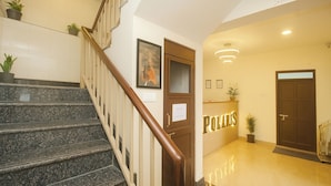 A hotel lobby with a staircase, a reception desk, and a door labeled "POLARIS". - TVD Hotel Polaris Near Mg Marg (Gangtok)