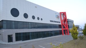 A modern building with large windows and a prominent red structure. - Arena Hotel Yardimli (Yardimli)