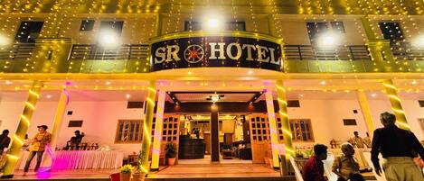A hotel entrance with a sign reading "SR HOTEL" and a decorative floor pattern.