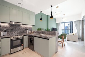 Deluxe Apartment, Balcony | Private kitchen | Fridge, microwave, oven, stovetop - KeyRock Living - Luxe Escape with Pool (Dubai)