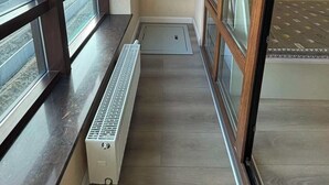 A narrow balcony with a radiator, a window, and a door. -  205 In the central of Ulaanbaatar, Selbe Comfort Apartment (Ulaanbaatar)