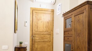 Un couloir doté d’un plancher en bois, d’une porte en bois et d’un meuble en bois.