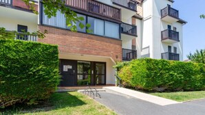 A modern multi-story residential building with a brick facade, large windows, and balconies. - Cabourg Plage by Interhome (Cabourg)