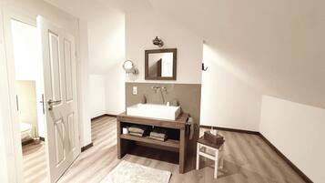 A modern bathroom with a white sink, wooden vanity, a mirror, and a towel rack.