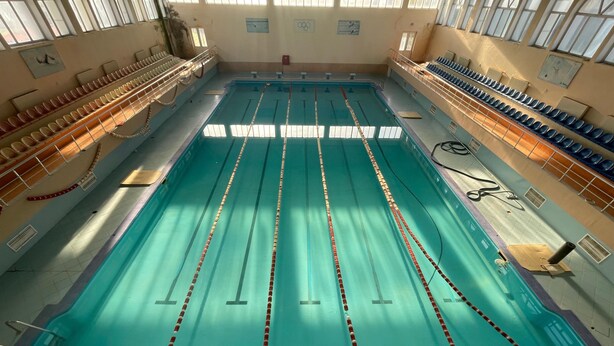 An indoor swimming pool with lanes, starting blocks, and spectator seating. - Arena Hotel Kurdamir (Kurdamir)