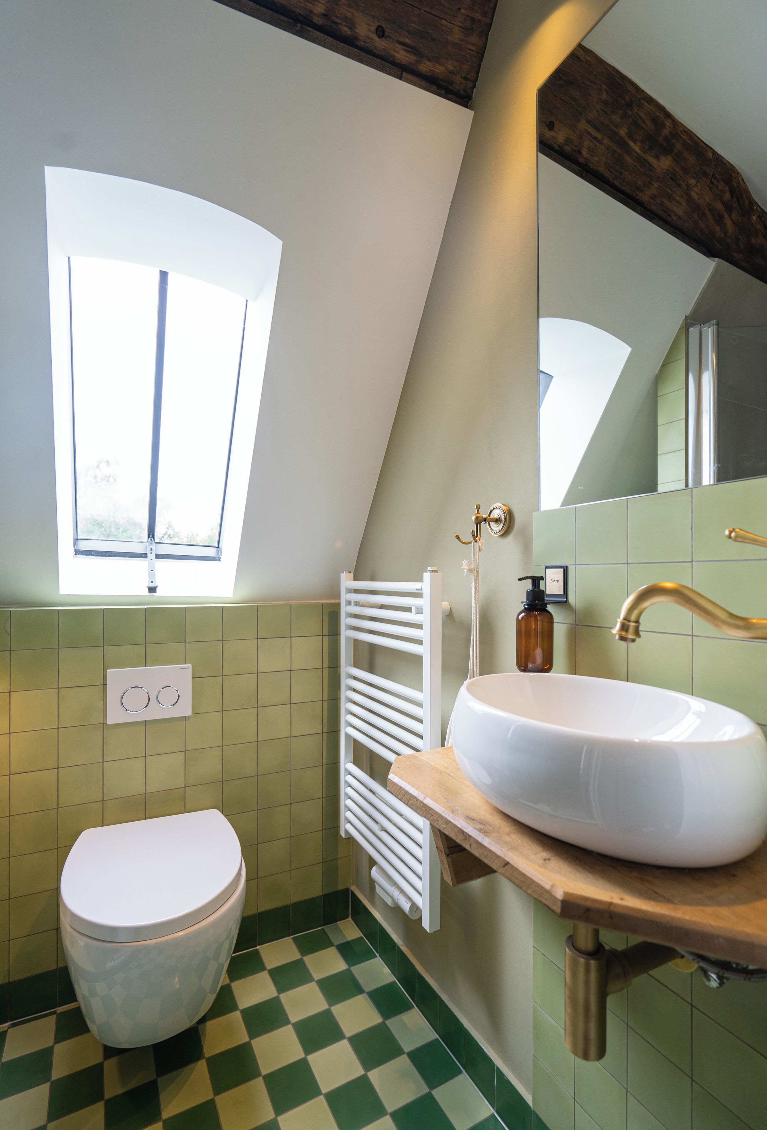 A bathroom with a white sink, a white toilet, and a window.