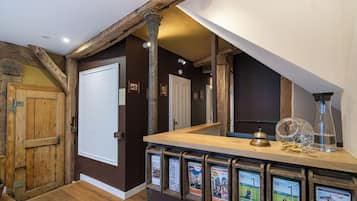 A wooden interior with a reception desk, framed informational posters, and a door.