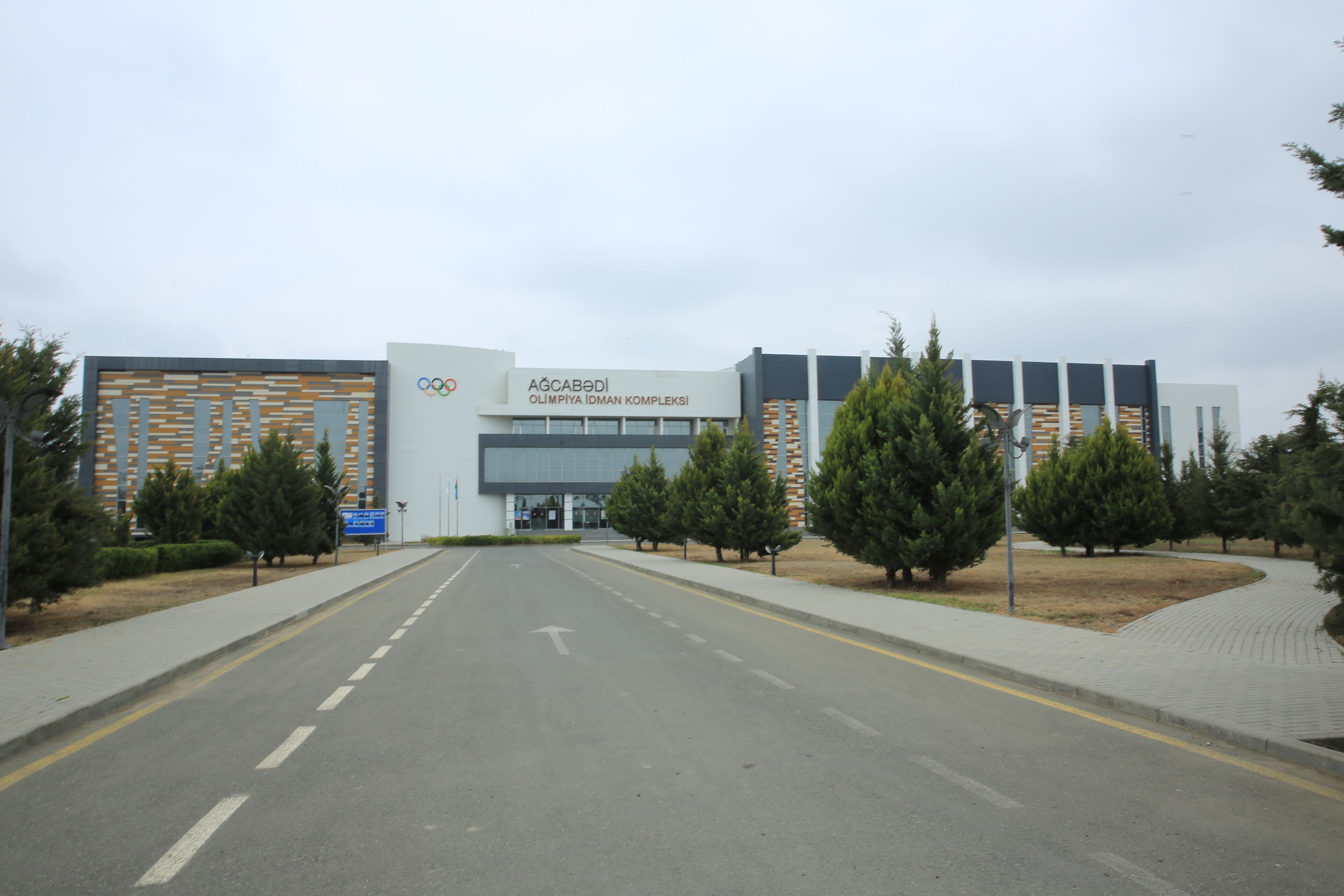 A modern building with a sign reading "Olympic Complex".