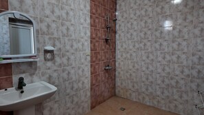 A bathroom with a sink, mirror, and shower. - Arena Hotel Astara (Astara)
