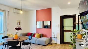 Design Apartment, 2 Bedrooms, Balcony, Courtyard View | Living area | Flat-screen TV