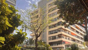 A multi-story building with balconies, surrounded by lush greenery and a clear sky. - Charming Studio in La Nogalera, Near Beach (Torremolinos)