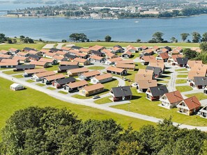 A residential area with houses arranged in rows, a marina with boats, and a body of water in the background. - 8 Person Holiday Home on a Holiday Park in Grasten (Grasten)