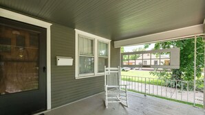 A covered porch with a wooden chair, a door, and windows. - 2 Bed 1 Bath home by College Hill and Hospitals (Wichita)
