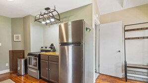 A modern kitchen with stainless steel appliances, wooden flooring, and a built-in oven. - 2 Bed 1 Bath home by College Hill and Hospitals (Wichita)