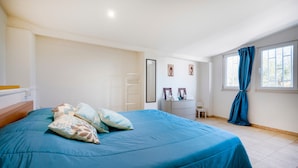 A bedroom with a bed, a dresser, a mirror, and a window with curtains. - Apartment 'La Campanella' with Shared Terrace, Wi-Fi and Air Conditioning (putignano)