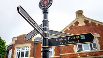 A directional signpost with multiple arms pointing to various destinations.