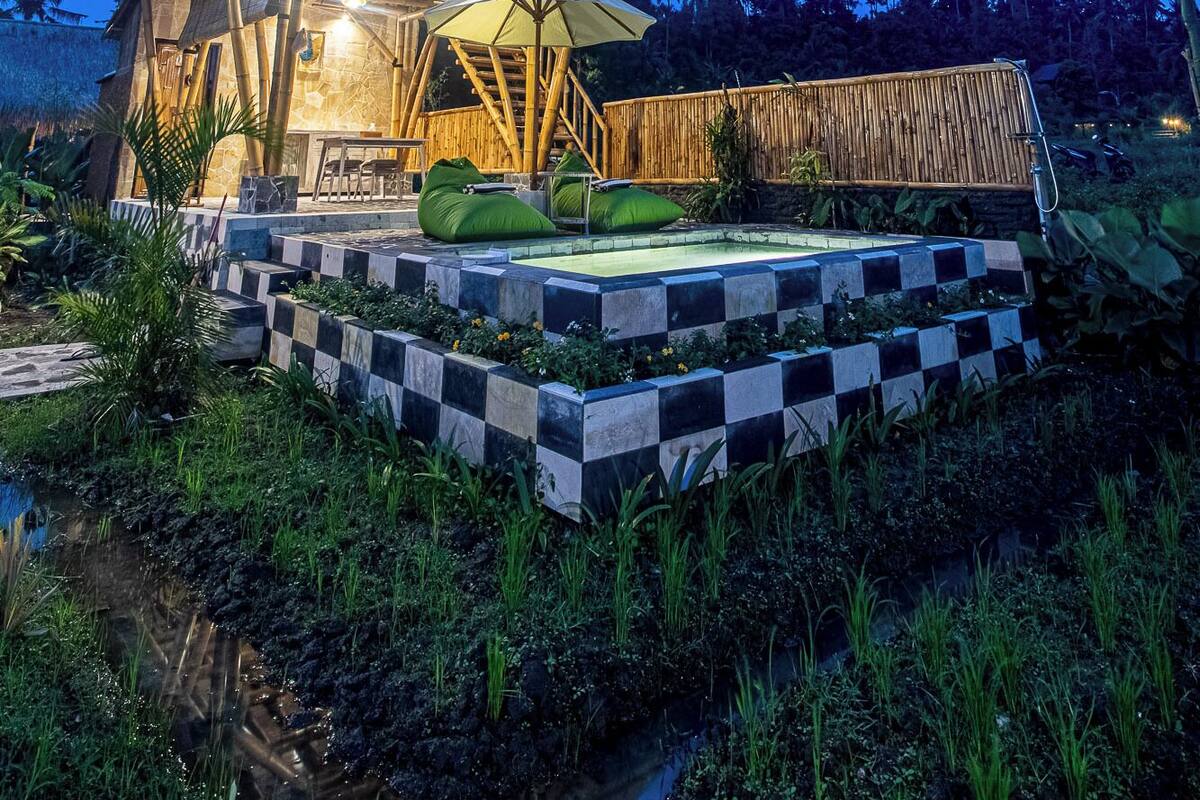 A multi-level wooden structure with a checkered border and a small pool area.