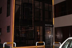 A building with a reception area, glass doors, and a sign indicating "RECEPTION". - Aqua Resort Naivasha (Naivasha)