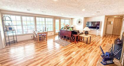 Welcome to Shooters Shoreline Escape, a lakefront home in Osage Beach at Lake of the Ozarks. This 4BR, 2.5BA retreat features a game room, sunroom, kids' bunk room, private dock, grill, and stunning views—perfect for a fun and relaxing lake getaway!