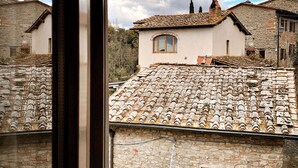 A stone building with a tiled roof, a window, and a chimney. - Nice apartment for 4 guests with WIFI, A/C, pool, TV, terrace, pets allowed and panoramic view (Penna)